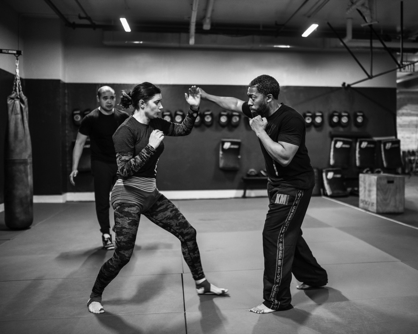 A beginner being coached through her guard at a KMI induction