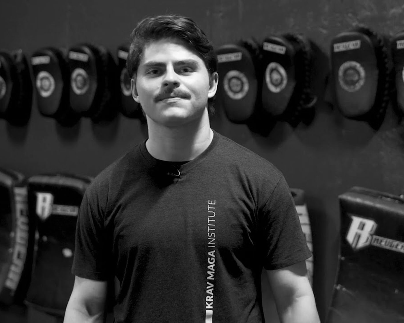 A KMI member in front of the pad wall at the TriBeCa studio
